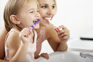 Mom Daughter brushing teeth